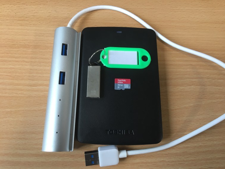 Photo of USB hub, hard drive, MicroSD card and USB flash drive